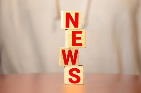 NEWS word on wooden block and newspaper