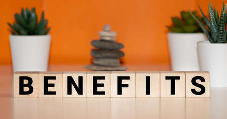 BENEFITS word written on wood block. BENEFITS text on wooden table for your desing, concept.の写真素材
