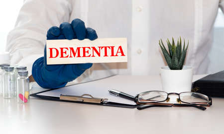 doctors holding a card have word dementiaの写真素材