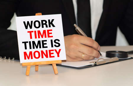 Time Management written on paper with wooden background desk, clock, dice, compass and pen.の写真素材