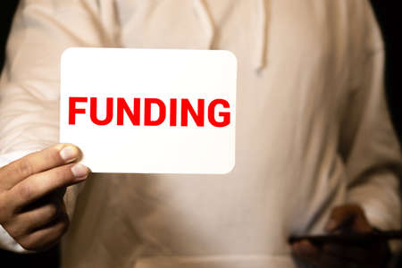 Businessman put card with text Funding in pocket. Business conceptの写真素材