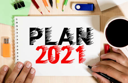 Plan 2021 words written in an office notebook. Concept in business. Plans for the new yearの写真素材