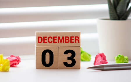 Wooden calendar December 03 on a white background close up.の写真素材