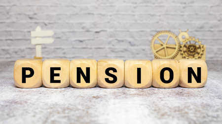 Wooden cubes with letters on the table in the office. Text PENSION. Financial conceptの写真素材