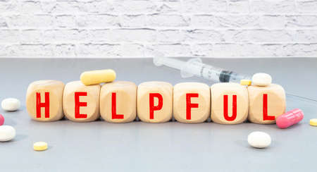 Top view of crossword with words helpful tips. Alphabet blocks with letters on the wooden boardの写真素材