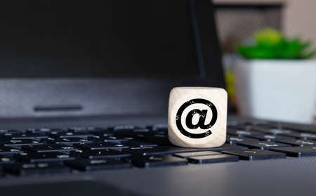 E-mail symbol on a laptop computer keyboard concept for email, communication or contact us.の写真素材