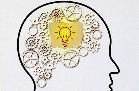 Clean and shiny lightbulb with a brain as a glowing wire.の写真素材