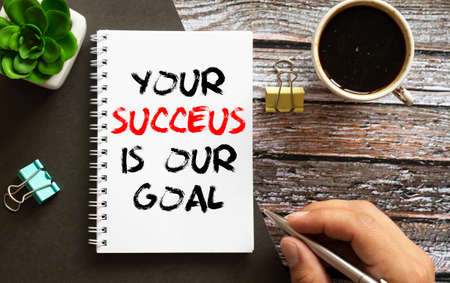 Your success is our goal text on notebook.の写真素材