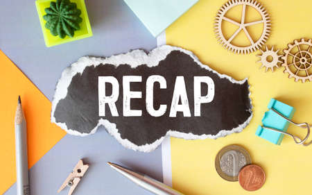 Recap - text on yellow note sheets on a dark wooden background with crumpled sheetsの写真素材