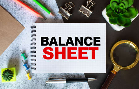 BALANCE SHEET. text on white paper on a gray background near the KEYBOARDの写真素材