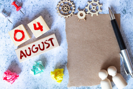 August 4. Date of August month. Number Cube with a flower and notebook on Diamond wood table for the...