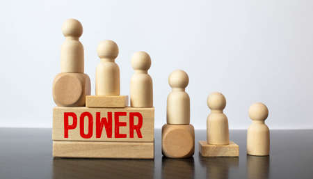 Businessman hand holding wooden cube block with POWER business word on table background. Words Have Power conceptの写真素材