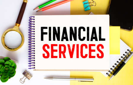 FINANCIAL SERVICE - text on a white business card with a blue graph and numbers.の写真素材