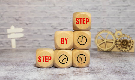 The word step by step on wooden cubes. Achievement or progress in business career