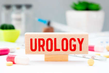 The word UROLOGY is written on wooden cubes near a stethoscope on a light table. Medical concept.の写真素材