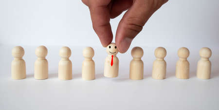 Gray background with wooden blocks of people silhouettes.の写真素材