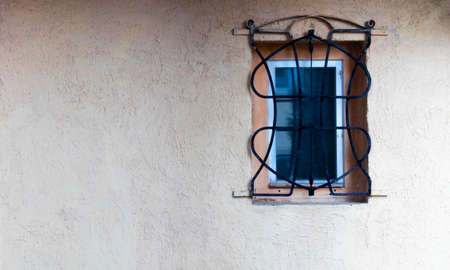Beautiful background photo of Exterior wall, painted fresh with solid color of peach. The wall is clean, plain and a Vintage Wooden Window with white outline is adding further glam. -Imageの写真素材