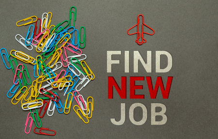 find new job - words writing a white letters on a sheet paper. Black card with text on a yellow background with round metal stand and metal writing pen. Business, finance and education conceptの写真素材