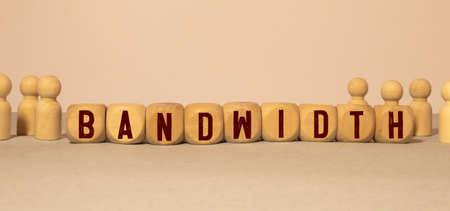 Wooden Blocks with the text: BANDWIDTH. The text is written in black letters and is reflected in the mirror surface of the table. New business relaunch startup concept.の写真素材