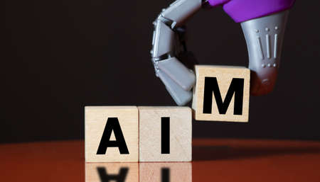 Group of people standing in front of the word AIM. Goals concept.の写真素材