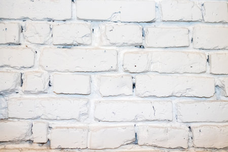 deep cracked white silicate brick wall closeup texture and background.