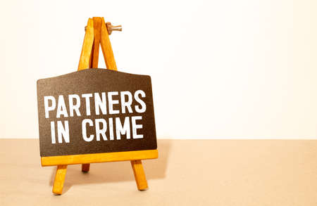 Businessman holding a card with text Partners in Crimeの写真素材