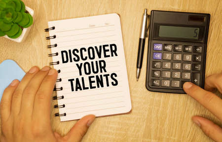 Businessman holding a card with text Discover Your Talents.の写真素材