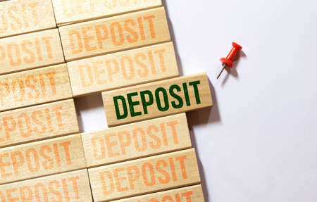 DEPOSIT word letters on wooden blocks with coins and chart. career concept,の写真素材