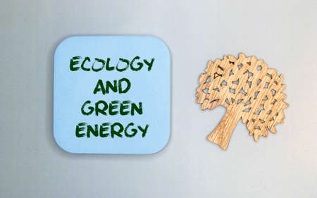 ecological concept. On a white-green background lies a pen and a notepad with the inscription - Ecology And Green Energy. There is a green leaf of a plant on the notebook.の写真素材