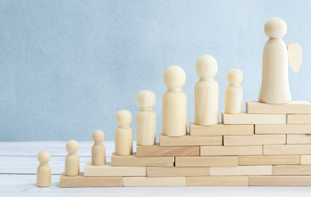 Three business people climbing a flight of stairs, white backgroundの写真素材
