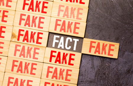 Puzzle made from wood with word fact and fake.の写真素材