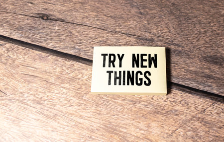 notepad with text TRY NEW THINGS in the wooden backgroundの写真素材