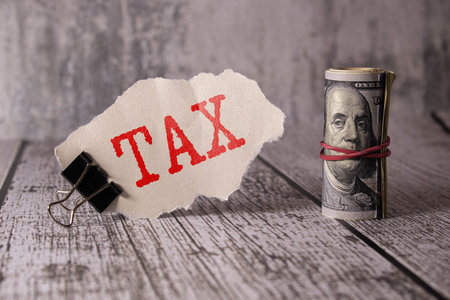 The word tax on a wooden block Business and tax ideas. Taxation. New year tax concept.の写真素材