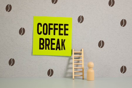 Coffee break inscription on wooden table backgroundの写真素材