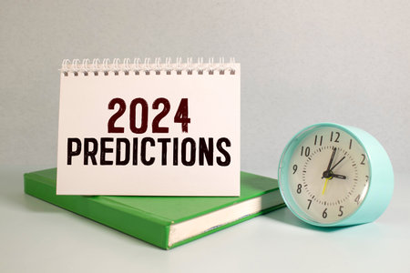 2024 predictions wooden table.yellow notepad and open notebook with textの写真素材