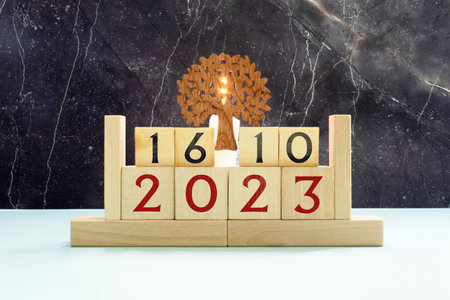 Wooden calendar with date October 16 and alarm clock on table against brick wall background. Deadline, planning, business conceptの写真素材