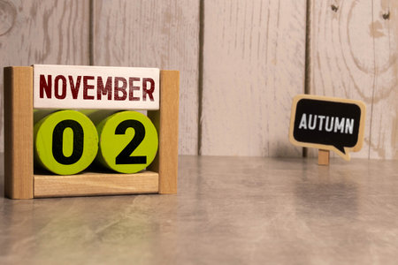November 2nd. November 2 white wooden calendar on vintage wood abstract background. Autumn day. Copyspace for your text.の写真素材