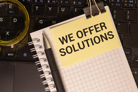 We offer solutions - business card. yellow sticker on a notepad. text.の写真素材