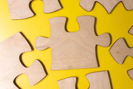 Photo puzzles scattered brown paper on the floor of wooden planksの写真素材