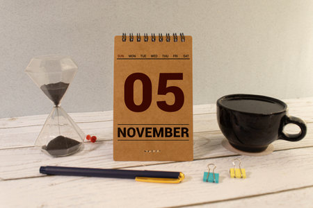 Wooden calendar on dark background, date 5 November.の写真素材