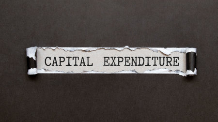 The text Capital Expenditures behind torn brown paper.の写真素材