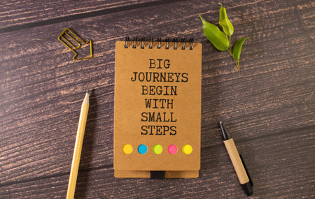 Text big journeys begin with small steps on note paper.の写真素材