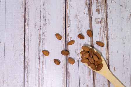 Crunchy granola, muesli pile in wooden spoon with nuts isolated on white background, top view.の写真素材