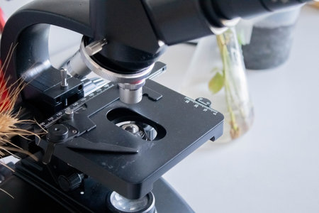 Microscope on table for vintage science background.の写真素材