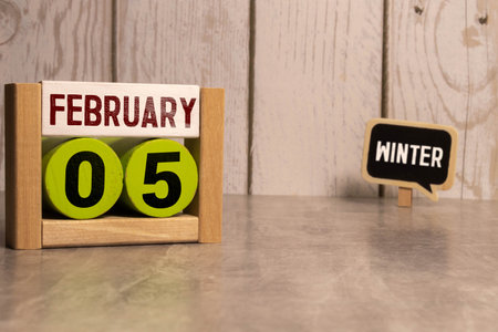 5 February on wooden gray cubes. Calendar cube date 05 February. Concept of date. Copy space for text or event. Educational cubes. Cube shape calendar for February 5 with empty space. Selective focusの写真素材