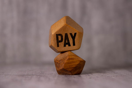 hand putting wood cube block increasing on top with letter P upward direction. PAY text. financial, management, economic, business concept.の写真素材