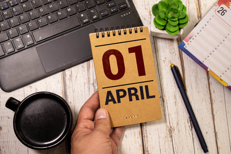 April 1st. Image of april 1 wooden color calendar on white background. Spring day, empty space for text.の写真素材