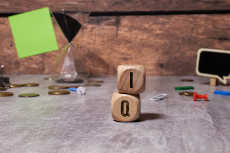 Text IQ on wooden cubes on a pink background, copy space. Coefficient intelligence concept.の写真素材