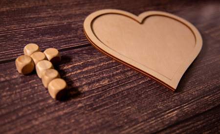 Wooden background with olive heart and white cross for an obituary noticeの写真素材