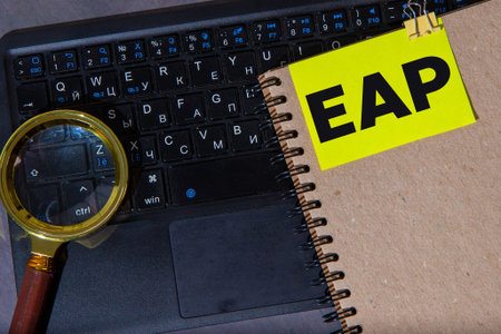 On a light background, a brown notebook, a black pen and paper clips, and a yellow card with the...